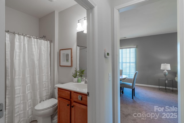 bathroom featuring vanity, curtained shower, and toilet