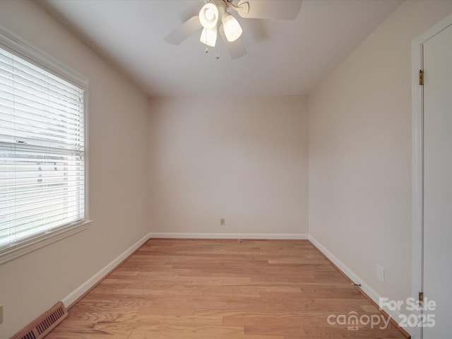 spare room with ceiling fan and light wood-type flooring