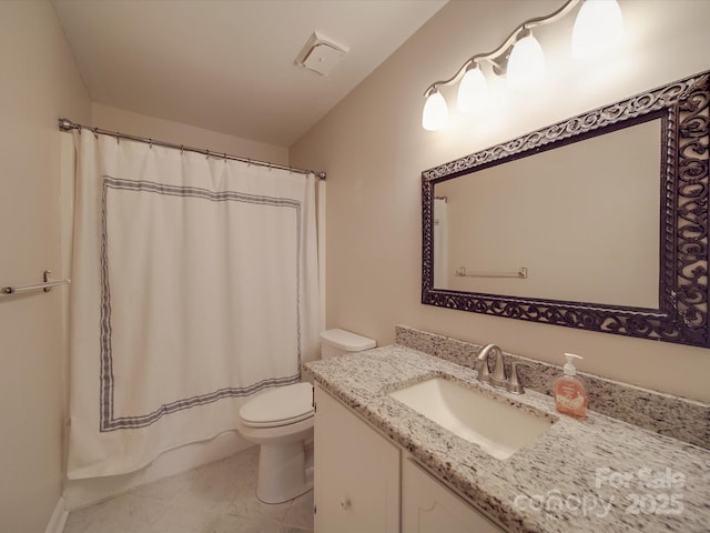 bathroom featuring toilet, vanity, and tile patterned flooring