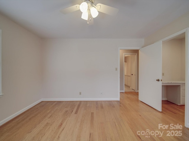 empty room with ceiling fan and light wood-type flooring