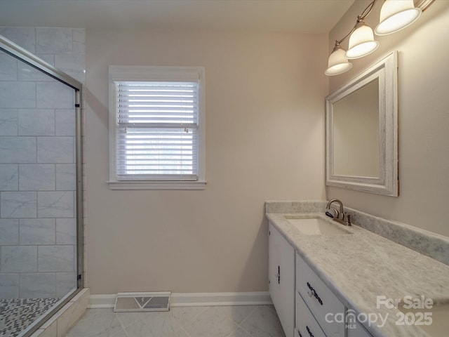 bathroom with vanity and a shower with door