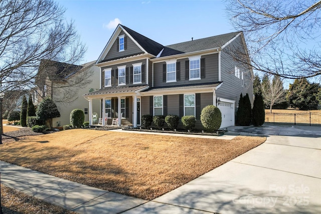 view of front of home featuring a front yard, a porch, and a garage