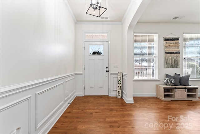 foyer featuring crown molding and hardwood / wood-style floors