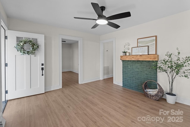 unfurnished living room with ceiling fan and light hardwood / wood-style flooring