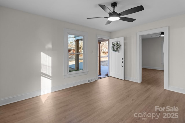 spare room featuring ceiling fan and light hardwood / wood-style flooring