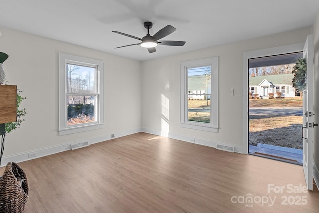 unfurnished room featuring light wood-type flooring and ceiling fan