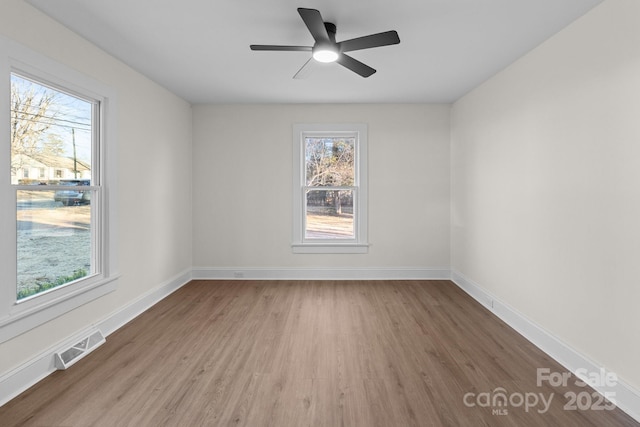 spare room featuring ceiling fan and hardwood / wood-style floors