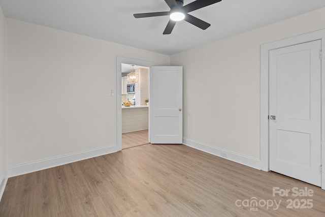 unfurnished bedroom featuring ceiling fan and light hardwood / wood-style flooring