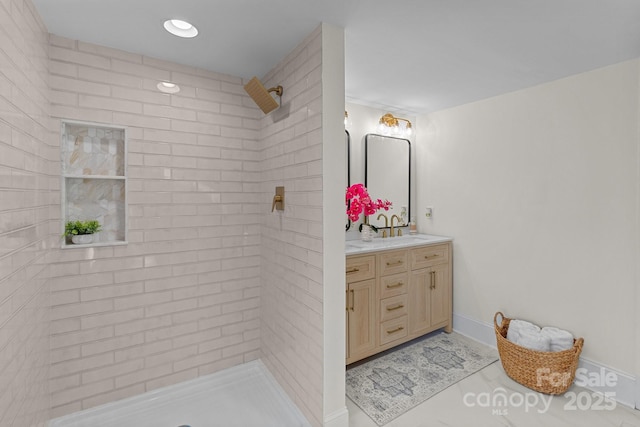 bathroom featuring vanity and a tile shower