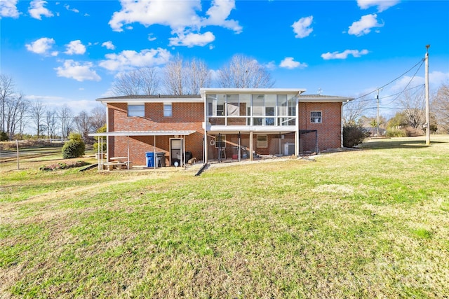 back of house with a yard and a sunroom