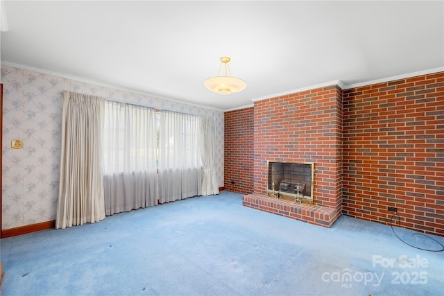 unfurnished living room featuring a brick fireplace, crown molding, and carpet