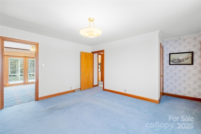 carpeted empty room featuring ornamental molding