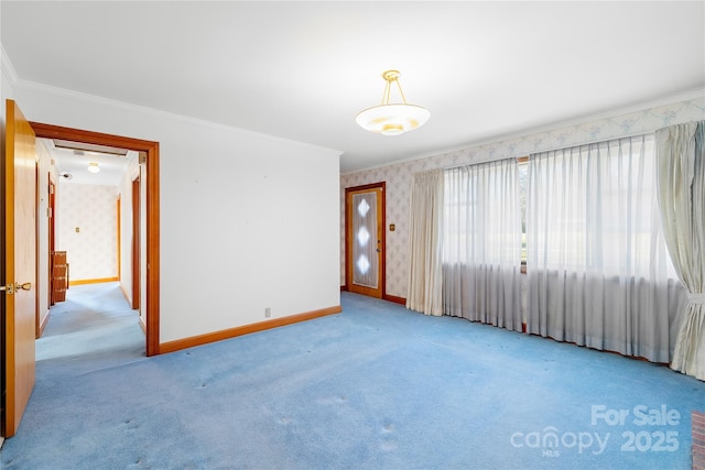 carpeted spare room with crown molding