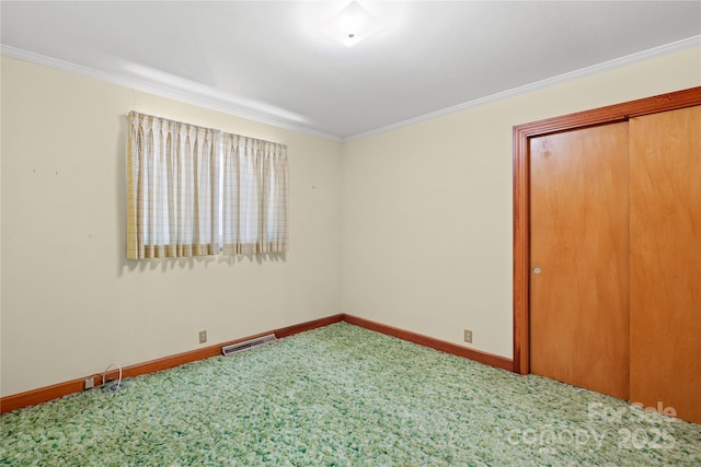 unfurnished bedroom featuring carpet flooring, a closet, and crown molding