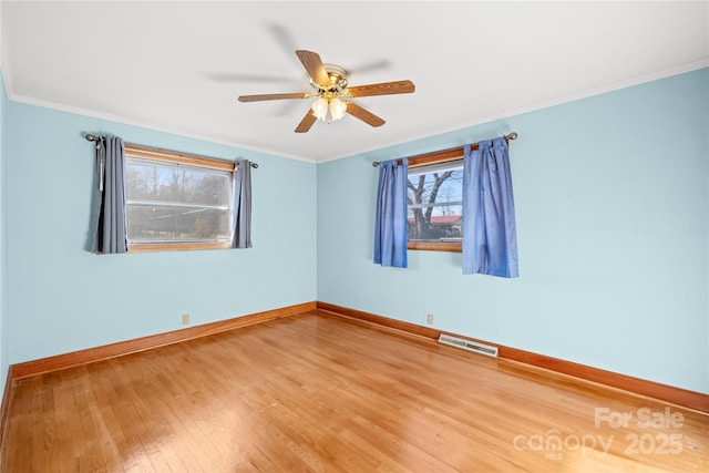 spare room featuring ceiling fan, ornamental molding, and hardwood / wood-style flooring