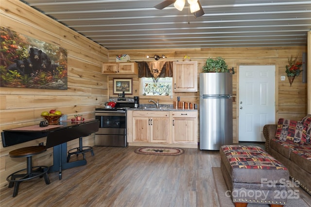 kitchen featuring ceiling fan, stainless steel appliances, light brown cabinetry, and dark wood-type flooring