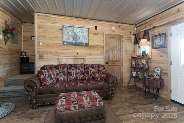 living room with hardwood / wood-style floors and wood walls