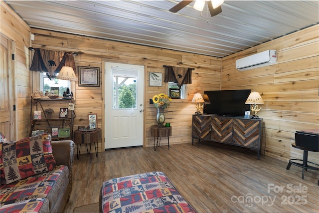 living room with wood ceiling, hardwood / wood-style floors, wooden walls, and a wall unit AC