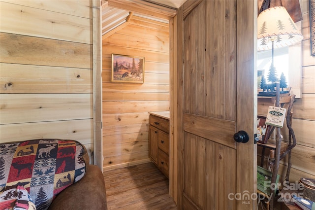 interior space with wooden walls and hardwood / wood-style flooring