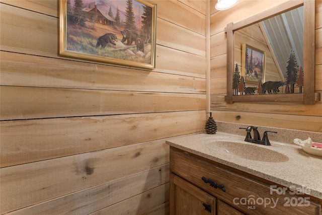 bathroom with wooden walls and vanity