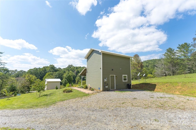 view of outbuilding with a lawn