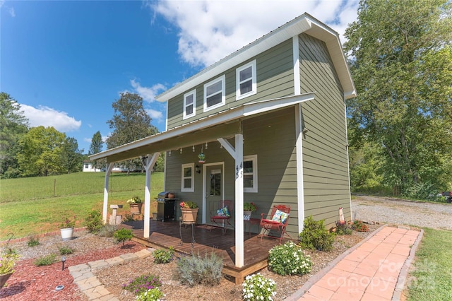 view of front of property with a front lawn and a wooden deck