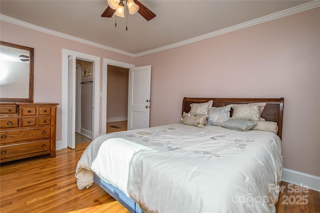 bedroom featuring a closet, ceiling fan, crown molding, and light hardwood / wood-style flooring