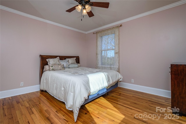 bedroom with hardwood / wood-style floors, ceiling fan, and ornamental molding