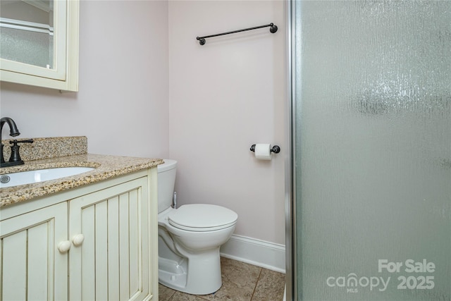 bathroom featuring toilet, tile patterned flooring, a shower with shower door, and vanity