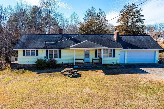 single story home with a front yard, a porch, and a garage