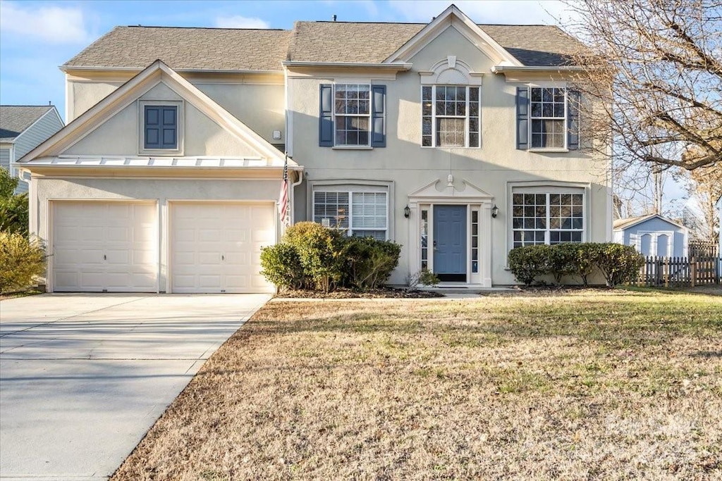 view of front of home with a front yard and a garage