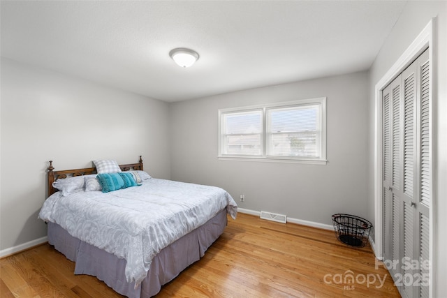 bedroom with a closet and light wood-type flooring