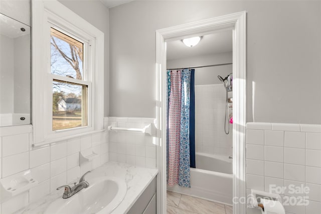 bathroom featuring shower / tub combo, vanity, and tile walls