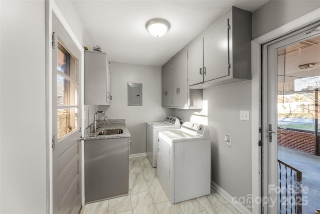 clothes washing area featuring cabinets, a wealth of natural light, sink, washer and dryer, and electric panel