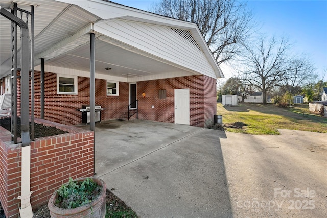 view of property exterior featuring a carport and a lawn