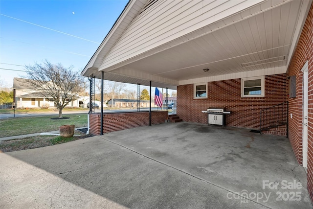 view of patio with a carport and a grill