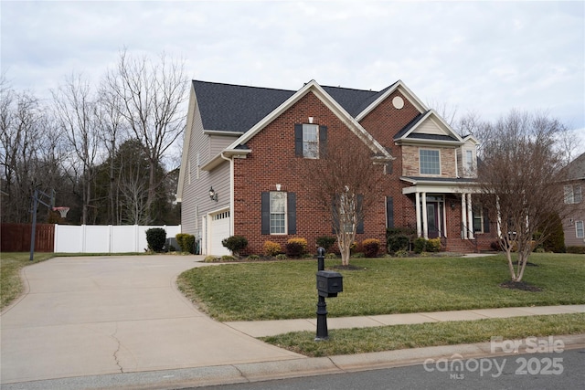 view of front of house with a garage and a front lawn