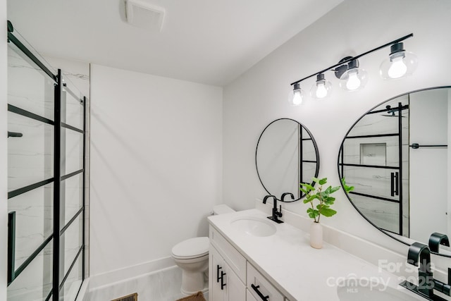 bathroom featuring vanity, toilet, and a shower