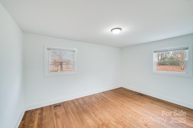 empty room with hardwood / wood-style floors