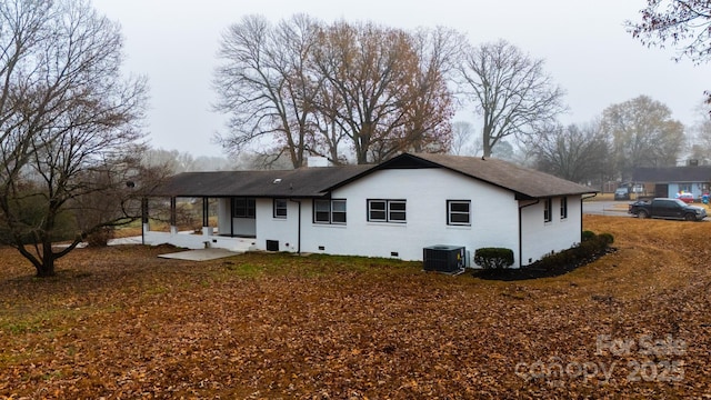 rear view of property featuring central AC unit