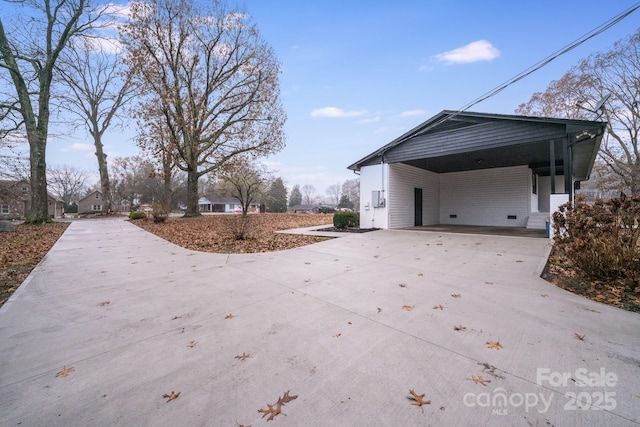 view of side of home with a carport