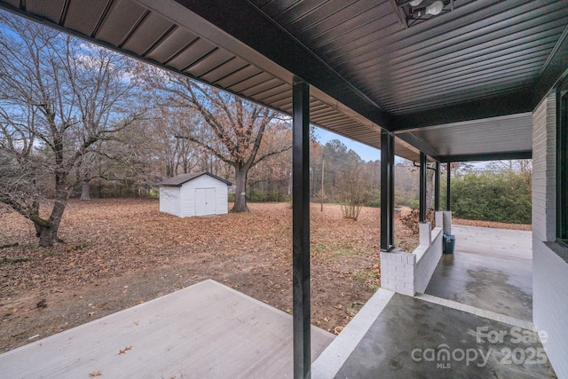 view of patio with a storage shed