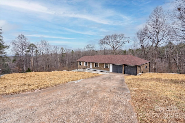 ranch-style home featuring a front yard and a garage