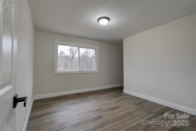 empty room featuring dark wood-type flooring