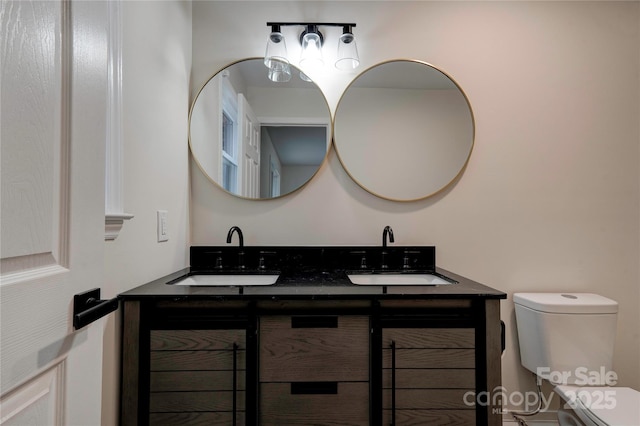 bathroom featuring toilet and vanity