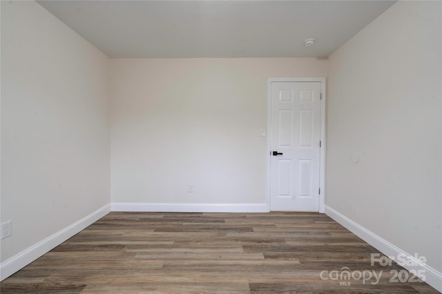 empty room with hardwood / wood-style flooring