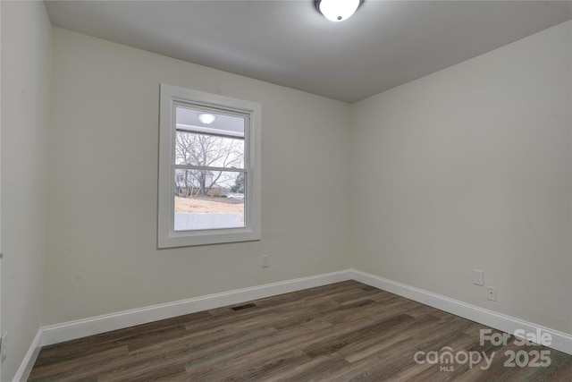 spare room featuring dark hardwood / wood-style flooring