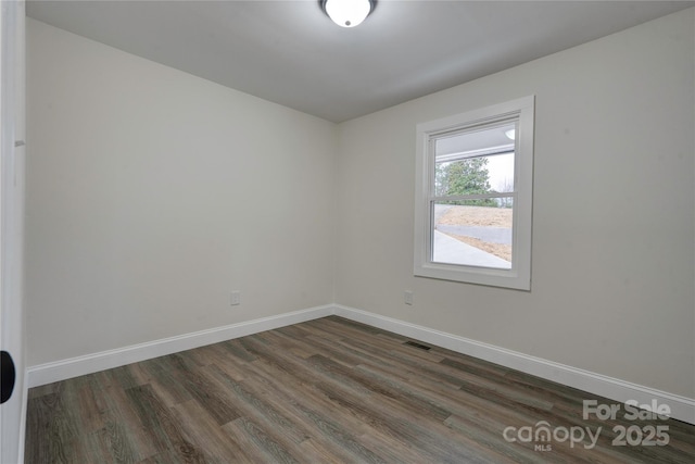 spare room with dark hardwood / wood-style floors