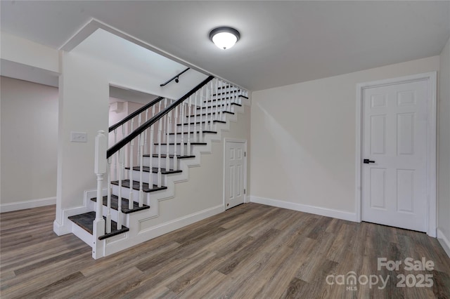 staircase with wood-type flooring