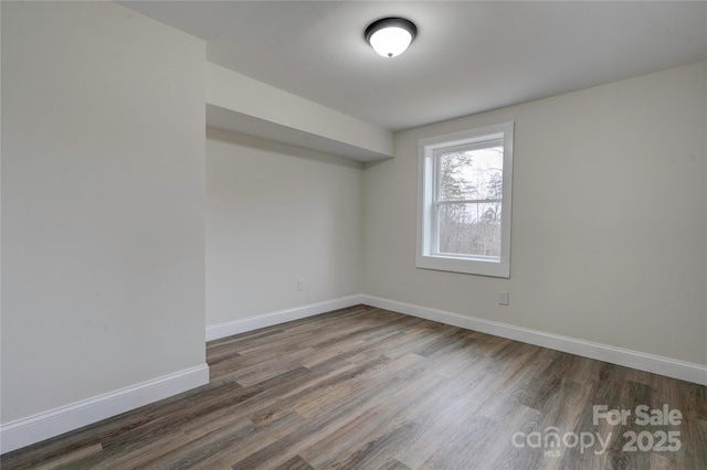 unfurnished room with dark hardwood / wood-style flooring